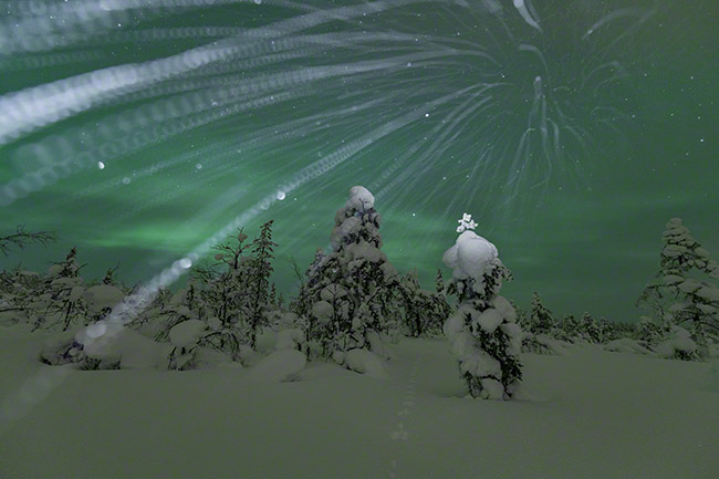 Snowflake trails with northern lights