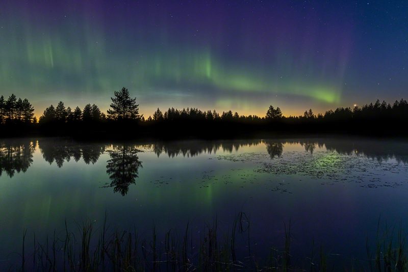 Northern lights above a lake